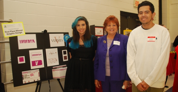 Jeannette Santos, board member of Western Suffolk BOCES, congratulates Melanie Wolff and Luis Alvarado-Rodriquez won first place in the in the Huntington Chamber of Commerce’s 12th annual Business Leadership Competition.