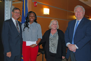 Christina Brown of Amityville, a student in the Physical Therapy Aide program, is congratulated on her scholarship award.