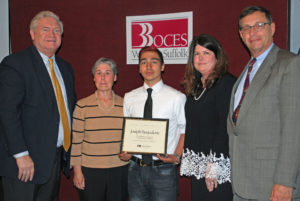 Joseph Pasqualone (center) is congratulated by (from left) COO Michael Flynn, HVAC teacher Elizabeth Cohen, Executive Director Nancy Kelsey and Board President Peter Wunsch.
